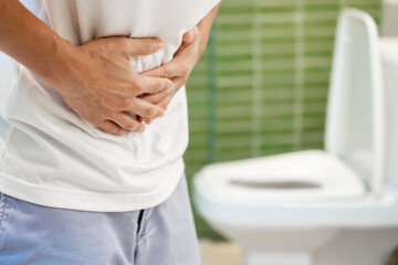 Constipation and diarrhea in bathroom. Hurt man touch belly  stomach ache painful. colon...