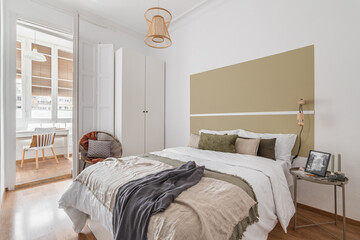 Spacious bright bedroom in beige tones in a luxury five-star hotel room. Interior in bright daylight. The concept of traveling and staying in luxury hotels