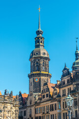 Fototapeta na wymiar Cityscape over historical and touristic center in Dresden downtown, old clock tower near Cathedral of Holy Trinity and theater square, Dresden, Germany, at summer sunny day and blue sky.