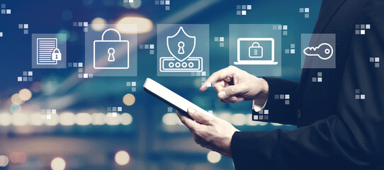 Cyber security theme with businessman using a tablet computer