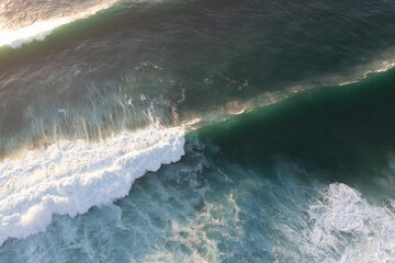 Aerial view of the white beach with waves 
Big ocean wave
Versatile use. Holiday concept