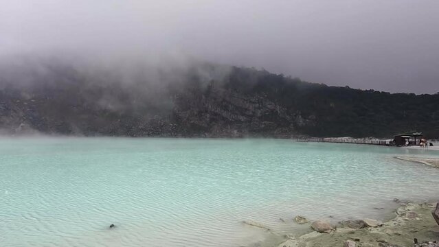 Kawah Putih or White Crater inside a volcanic crater in Ciwidey, West Java, Indonesia with a green sulfur lake.