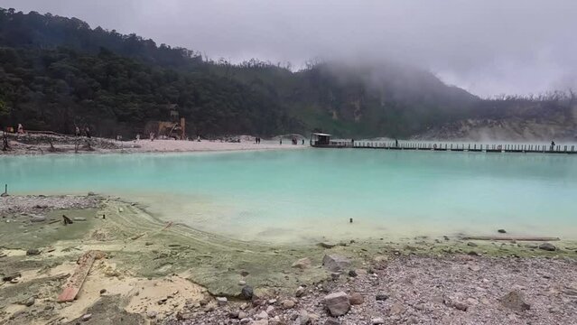 Kawah Putih or White Crater inside a volcanic crater in Ciwidey, West Java, Indonesia with a green sulfur lake.