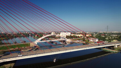 Aerial View Of Boat Going Under Cable-Stayed Bridge