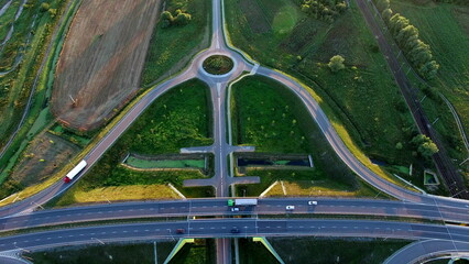Aerial Of Highway Junction And Trucks At Sunset
