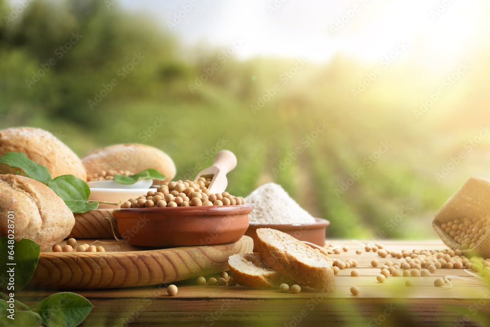 Wall mural Rustic table with soy products with harvest in the background