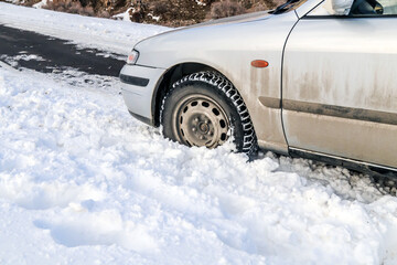 Car stuck in the snow on a mountain road