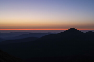 the first ray of light at dawn in the mountains, low-key photo, the first colors in the dawn sky