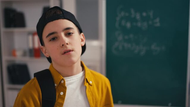 Portrait of an unruly schoolboy with attitude in the classroom, underachiever