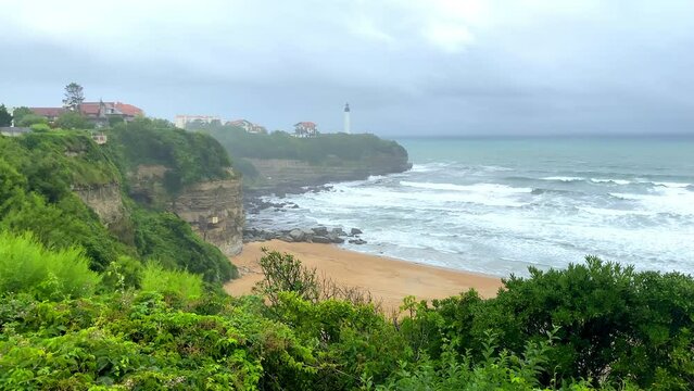 Pointe Saint-Martin and lighthouse of Biarritz seen from the Chambre d'amour beach in Anglet, France