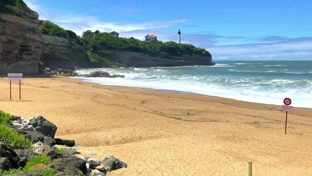 Pointe Saint-Martin and lighthouse of Biarritz seen from the Chambre d'amour beach in Anglet, France