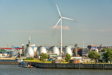 Gas storage reservoir and large wind turbine in the harbour area in Hamburg, Germany