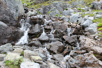 Mountain landscapes of Norway. The top of the mountain range, mountain lake. Hiking to Troltunga