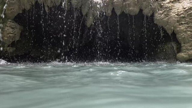Pretty cave under the Erawan waterfall in Kanchanaburi, Thailand, beauty of the waterfall in the middle of nature, underwater cave