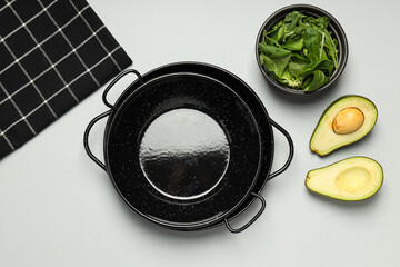A pan for cooking on the table, with ingredients.