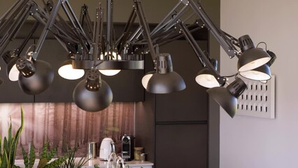 Slow revealing shot of a ceiling light with 14 light bulbs in the kitchen of a villa - Powered by Adobe