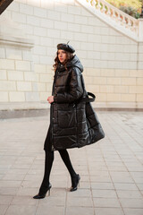 stylish woman in winter autumn fashion trend black puffer coat