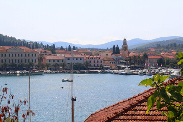 Picturesque small town Vela Luka, on island Korcula, in Croatia. Selective focus, pink oleander...