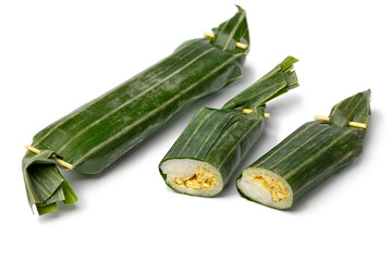 Whole and halved Lemper Ayam, an Indonesian savoury snack made of glutinous rice filled with seasoned shredded chicken isolated on white background