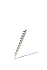 Silver grey classic ballpoint pen writing on white surface with its shadow. Isolated on white background with clipping path
