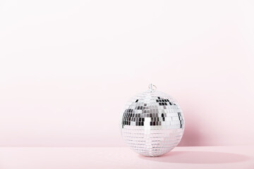 Disco ball on vintage styled background. Minimalistic stylish concept.
