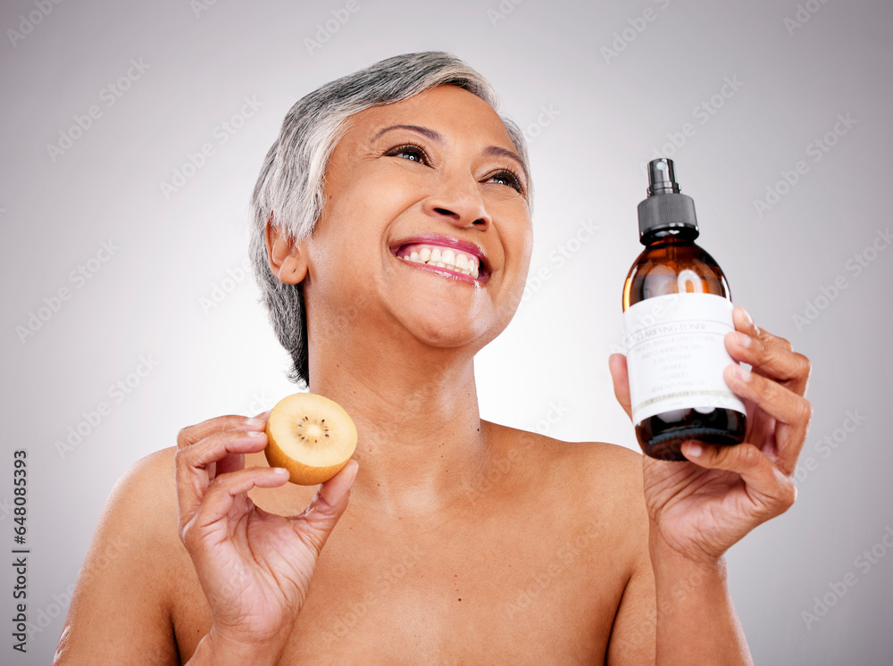 Sticker Kiwi, skin care and a woman with product for dermatology, cosmetics and wellness glow. Happy mature female person with fruit and bottle for facial treatment, nutrition and beauty on a grey background