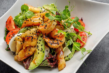 Grilled prawns with avocado, tomatoes, and quail eggs. Close up