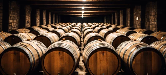 Gordijnen Oak wine barrels in old dark wine cellar Stacks of cognac, brandy, beer, whiskey barrels are made in a warehouse, An underground cellar for the wine aging process. Perfect for deliciously aging wine © chiew