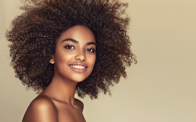 Beautiful black woman . Beauty portrait of african american woman with clean healthy skin on beige background. Smiling beautiful afro girl.Curly black hair .Afro Hairstyle