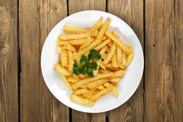 Roasted tasty fry potatoes on dark desk