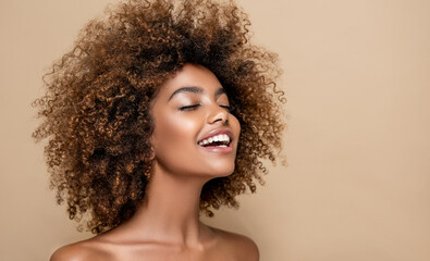 Beautiful black woman . Beauty portrait of african american woman with clean healthy skin on beige background. Smiling beautiful afro girl.Curly black hair . Afro Hairstyle - 648093536