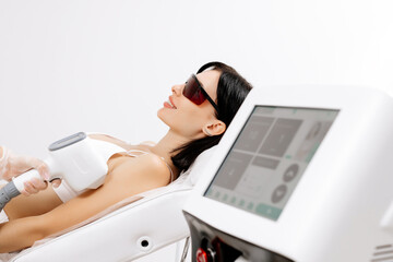 Hair removal-depilation. A young woman undergoes a laser hair removal procedure, close-up. Dermatology, photorejuvenation. Cosmetic clinic. Laser hair removal.