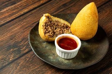 two traditional Brazilian coxinhas. typical fried snack food stuffed with meat and chicken