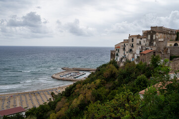 Naklejka premium Sandy beach of medieval small touristic coastal town Sperlonga and sea shore, Latina, Italy on sunrise in summer