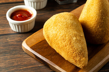 two traditional Brazilian coxinhas. typical fried snack food stuffed with meat and chicken