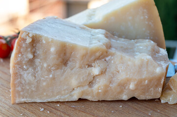 Traditional italian food - 36 months aged in caves Italian parmesan hard cheese from Parmigiano-Reggiano, Italy
