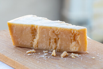 Traditional italian food - 36 months aged in caves Italian parmesan hard cheese from Parmigiano-Reggiano, Italy