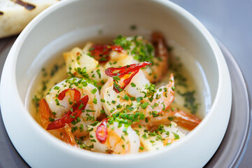 Shrimp pil-pil. King prawns, garlic, chilli and baguette. Delicious Spanish traditional food closeup served for lunch in modern gourmet cuisine restaurant - 648105940