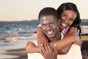 Happy young couple on sea side background