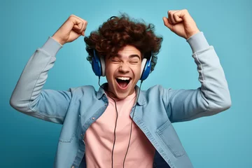  Happy funny gen z teen guy wearing headphones dancing and listening music © Volodymyr