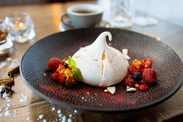 Pavlova berry cake with passion cream, strawberry, meringue. Delicious sweet dessert food closeup served for lunch in modern gourmet cuisine restaurant - 648108995