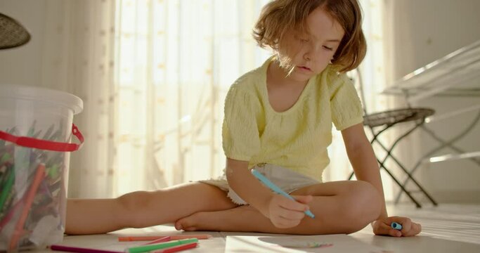 Joy of Artistic Expression: Preschool Girl Enchants with her Imagination and Colorful Pencils. High quality 4k footage