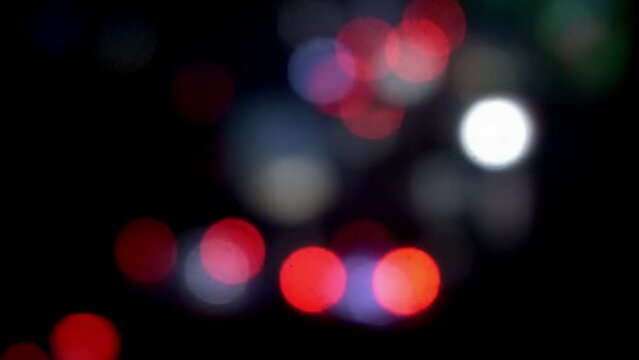 Headlights of moving cars and city lights in large bokeh,Blurring background car lights.Blured Night Traffic Car Lights on Busy Street bangladesh. Beautiful Bokeh Background. 4K.