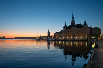 Dusk over the lake in central Stockholm, with the skyline visible, the town hall and parts of Riddarholmen's old buildings. Copy space
