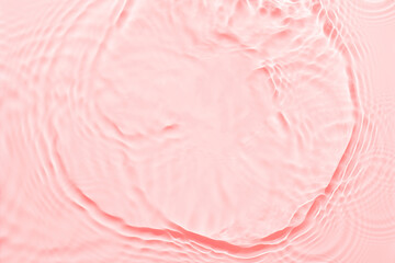 Water pink surface abstract background. Waves and ripples texture of cosmetic aqua moisturizer with bubbles.