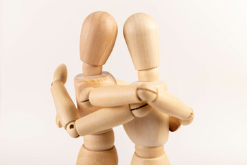 Hug concept. Drawing on a chalkboard. Support service for those in need. Wooden people