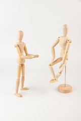 two wooden figures of people communicate emotionally.