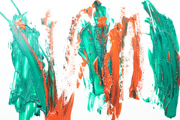 Acrylic paint blot, chaotic brushstroke, spot flowing on white paper background. Creative green orange color backdrop, fluid art.