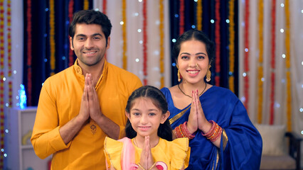 A small nuclear Indian family greeting people on Diwali - Indian culture  namaste gesture  Diwali...