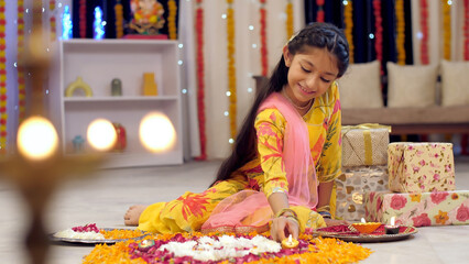 A cute happy girl decorating rangoli with Diya  Colorful house  Diwali festival decoration. Video of a cute Indian girl wearing an Indian dress decorating her home with diya and rangoli  Deepawali ...